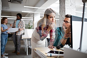 Programmers cooperating at IT company developing apps