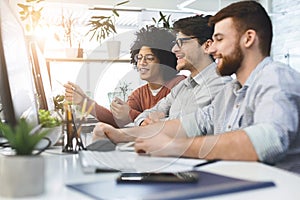 Programmers cooperating at IT company developing apps