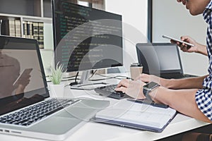 Programmers cooperating at Developing programming and website working in a software develop company office, writing codes and