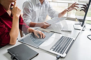 Programmers cooperating at Developing programming and website working in a software develop company office, writing codes and