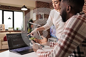 Programmers couple coding security firewall on laptop