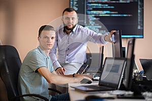 Programmers engrossed in deep collaboration, diligently working together to solve complex problems