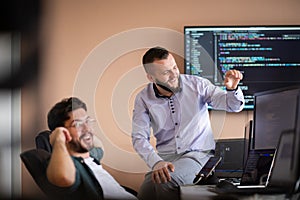 Programmers engrossed in deep collaboration, diligently working together to solve complex problems