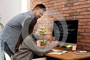 Programmers working with computer in office