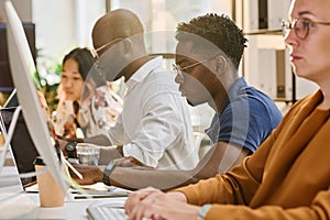 Programmers writing codes on computers