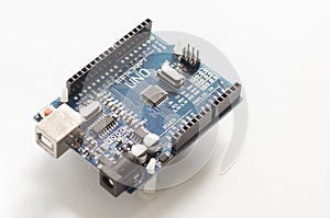 Programming board of Arduino UNO in blue colour isolated in white background
