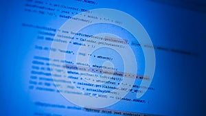Programming code on blue monitor background. Computer language