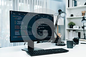 Programming code on computer screen desktop placing on working desk. Infobahn.