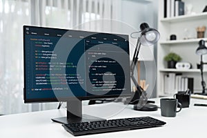 Programming code on computer screen desktop placing on working desk. Infobahn.