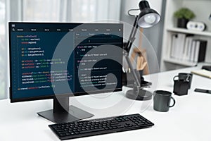 Programming code on computer screen desktop placing on working desk. Infobahn.