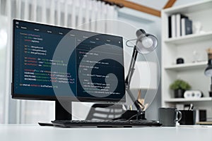 Programming code on computer screen desktop placing on working desk. Infobahn.