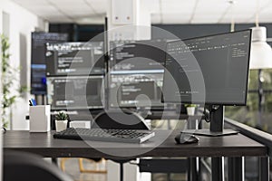 Programming code displayed on multiple computer monitors in office