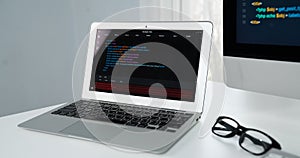Programming code on laptop monitor and beside screen pc desktop. Tastemaker.