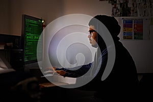 Programming, computer and man with hacker, night or cyber security with online database, malware or password phising photo