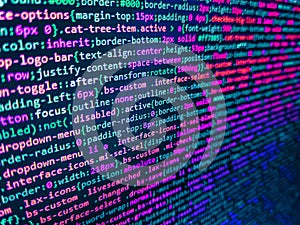 Programming Javascript on laptop computer screen. HTML5 concept macro backdrop in warm colors. HTML5 in editor for website
