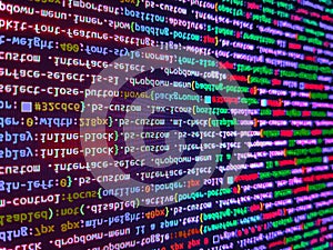 Programming Javascript on laptop computer screen. Matrix byte of binary data rian code running abstract background in dark blue