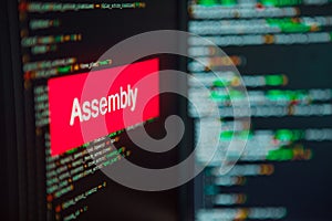 Programming language, Assembly inscription on the background of computer code.