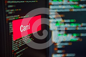 Programming language, Objective Caml inscription on the background of computer code