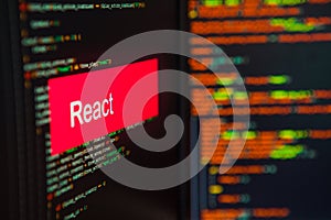 Programming language, React inscription on the background of computer code.