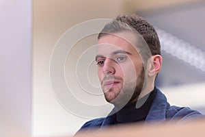 Programming. Man working on computer in it office, sitting at desk writing codes. Programmer typing data code, working on project