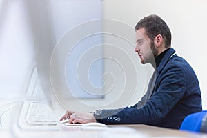 Programming. Man working on computer in it office, sitting at desk writing codes. Programmer typing data code, working on project