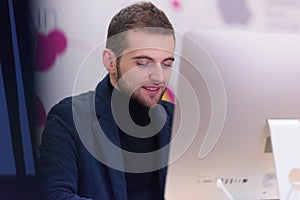 Programming. Man working on computer in it office, sitting at desk writing codes. Programmer typing data code, working on project