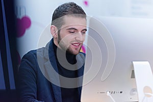 Programming. Man working on computer in it office, sitting at desk writing codes. Programmer typing data code, working on project