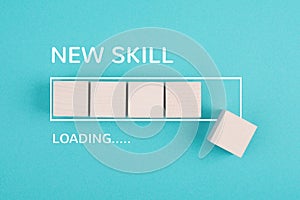 Progress bar with the words new skill loading, education concept, goal, online learning, knowledge is power strategy