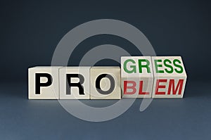 Progress or Problem. The cubes form the choice words Progress or Problem