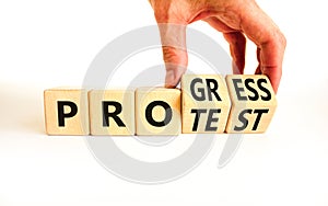 Progress vs protest symbol. Concept word Progress Protest on beautiful wooden cubes. Beautiful white table white background.