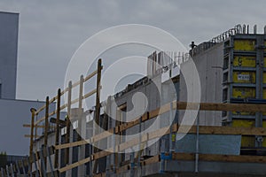 Progression of building with temporary wood elements and industrial ambiance