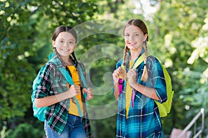 Progressive pupils. girls with school bags. child with backpack. happy time. Fashion little girls with backpack in park