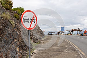 Prohibit overtaking sing post on a road side in the hilly mountain area