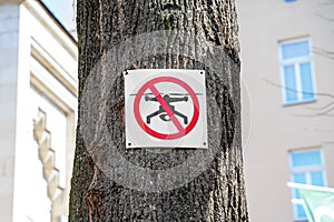 Prohibition sign that drones cannot be used in this area is hanging on tree