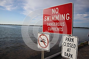 Prohibition sign swimming. No swimming allowed sign. Please don`t swim on the lake warning sign. Red indication informing to not s photo