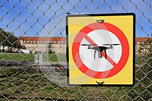 Prohibition sign to fly with drones on the fence. No drone zone.