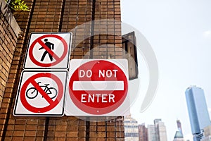 Prohibitive traffic sign on brick wall of street in New York City. No entry for people and bike
