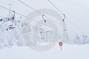 Prohibitory road sign No entry against the background of an empty ski surface lifts on a snowy ski slope