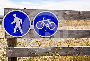 Prohibitory traffic sign. No car entry sign. No motor vehicle. Allow only bicycle and pedestrian on the wooden fence