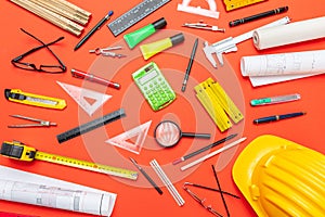 Project blueprints, hardhat and engineering tools on orange color