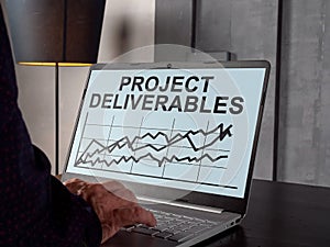 Project deliverables with charts on the laptop screen. photo
