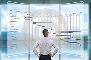 Project manager looking at AR screen, Gantt chart schedule, planning