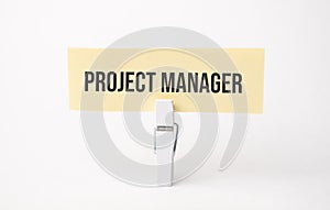 PROJECT MANAGER text on paper. On white background