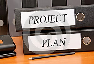 Project and Plan - two binders with text in the office