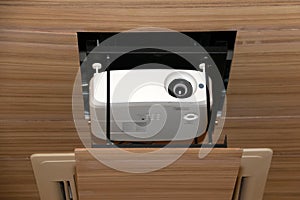 Projector hanging on meeting room ceiling