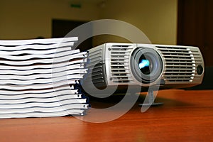 Projector with pile of books