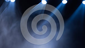 projectors light beam through smoke on stage