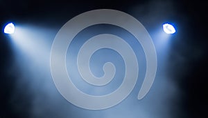 projectors light beam through smoke on stage