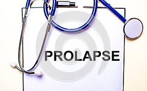 PROLAPS is written on white paper near the stethoscope. Medical concept