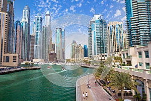 Promenade and canal in Dubai Marina with luxury skyscrapers around,United Arab Emirates